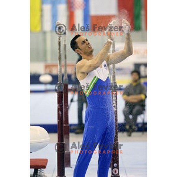 Alen Dimic of Slovenia competing at Parallel Bars during Artistic Gymnastics World Challenge Cup in Hala Tivoli, Ljubljana, Slovenia on April 20, 2014