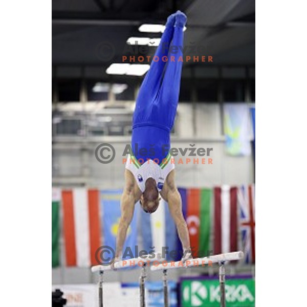 Alen Dimic of Slovenia competing at Parallel Bars during Artistic Gymnastics World Challenge Cup in Hala Tivoli, Ljubljana, Slovenia on April 20, 2014