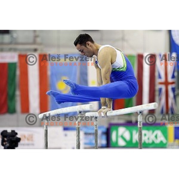 Alen Dimic of Slovenia competing at Parallel Bars during Artistic Gymnastics World Challenge Cup in Hala Tivoli, Ljubljana, Slovenia on April 20, 2014