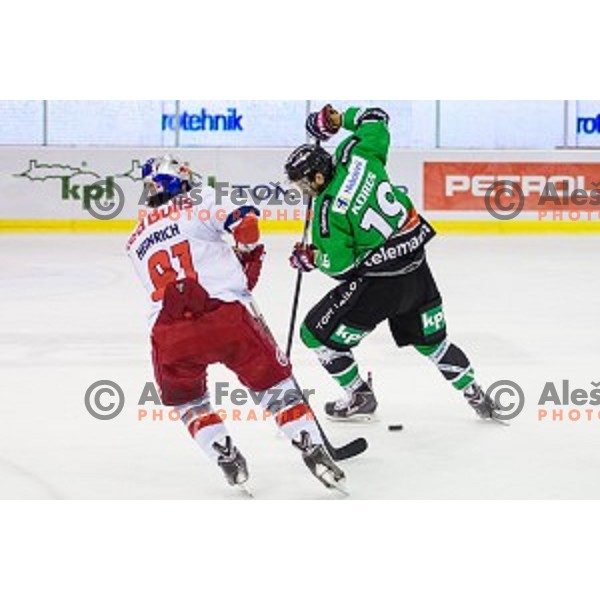 Dominique Heinrich of Salzburg and Gal Koren of Olimpija in action during ice hockey match of 10th round of EBEL League in Season 2014/15 between HDD Telemach Olimpija and EC Red Bull Salzburg, played in Tivoli Hall, Ljubljana, Slovenia, on October 12, 2014