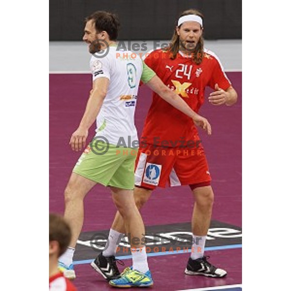 Jure Natek of Slovenia and Mikel Hansen of Denmark after placement match 5-8 between Slovenia and Denmark at Qatar 2015 World Handball championships in Al Sadd Sport Arena, Doha on January 30, 2015