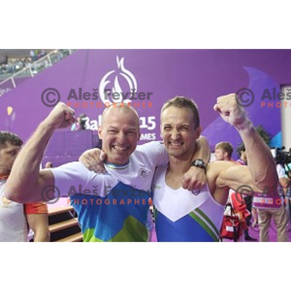 Coach Sebastjan Piletic and Saso Bertoncelj of Slovenia celebrate gold medal in Artistic Gymnastics at pommel horse at First European Games Baku 2015 in National Gymnastics Arena in Baku, Azerbaijan on June 20, 2015