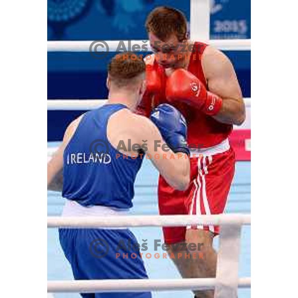 Aljaz Venko (red trunks) of Slovenia fights Michael O\'Rielly (blue trunks) in quarterfinals of Boxing tournament in Crystal Hall during First European Games Baku 2015, Azerbaijan on June 24, 2015