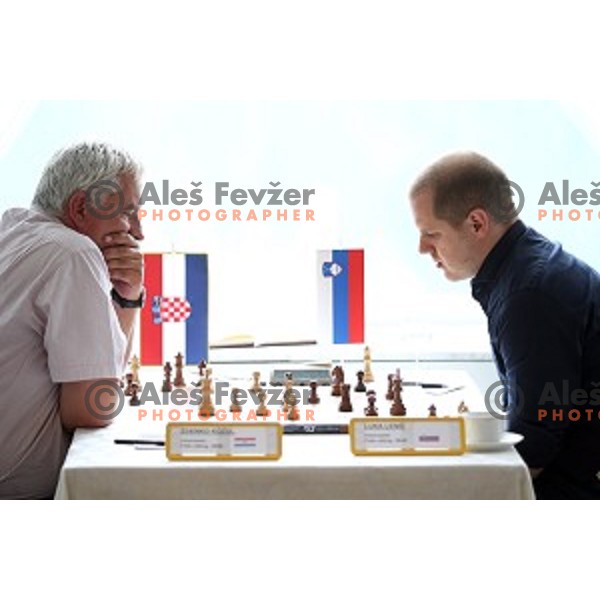 Zdenko Kozul of Croatia and Luka Lenic of Slovenia compete at Vidmar Memorial chess tournament in hotel Toplice, Bled, Slovenia on July 3, 2016