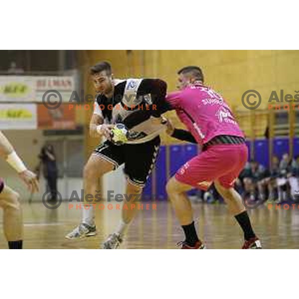 Blaz Nosan of Riko Ribnica and Matic Suholeznik in action during 1.NLB league handball match between Riko Ribnica and Celje Pivovarna Lasko in Ribnica Sports Centre, Slovenia on March 24, 2018