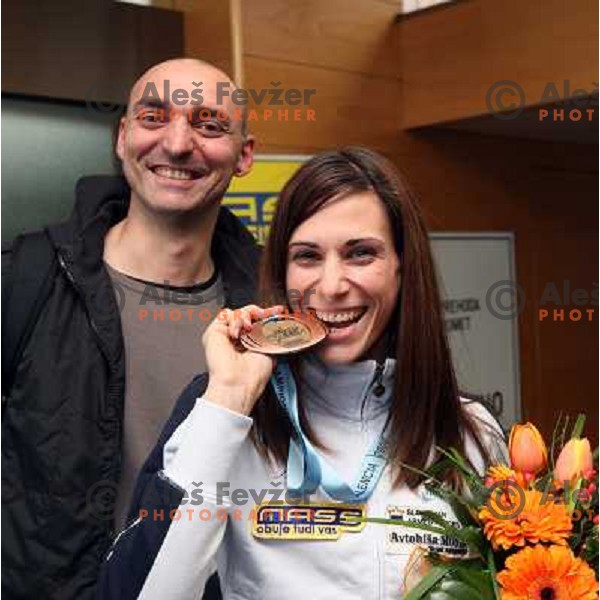 Matija Sestak smiles when Marija Sestak shows a medal from World Indoor Athletics Championships held in Valencia after she lands back home at Joze Pucnik Airport in Ljubljana 10.3.2008. Photo by Ales Fevzer 