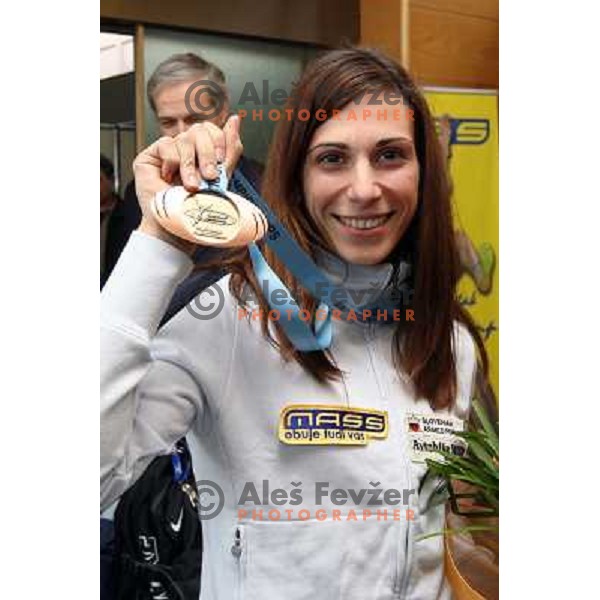 Marija Sestak shows a medal from World Indoor Athletics Championships held in Valencia after she lands back home at Joze Pucnik Airport in Ljubljana 10.3.2008. Photo by Ales Fevzer 