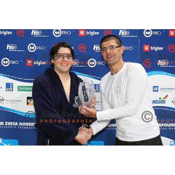 Matjaz Rakovec (left) President of Slovenian Waterpolo federation gives a trophy for second place to captain of Opatija Franciskovic at Alpe Adria waterpolo league tournament in Kranj 9.3.2008. Photo by Ales Fevzer 