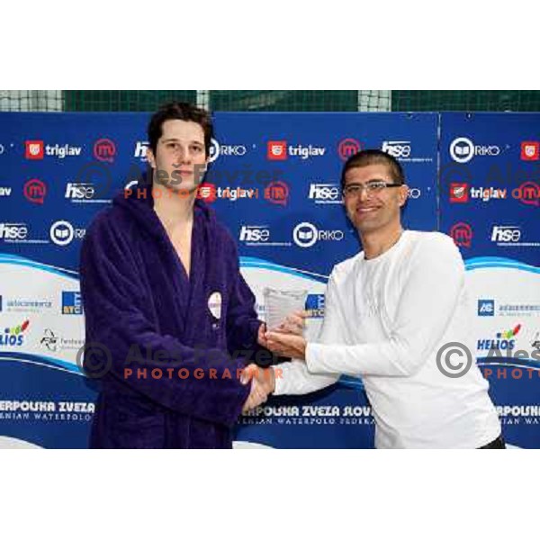 Matjaz Rakovec (left) President of Slovenian Waterpolo federation gives a trophy for best player to Balasz Somogyi (UTE) at Alpe Adria league tournament in Kranj 9.3.2008. Photo by Ales Fevzer 