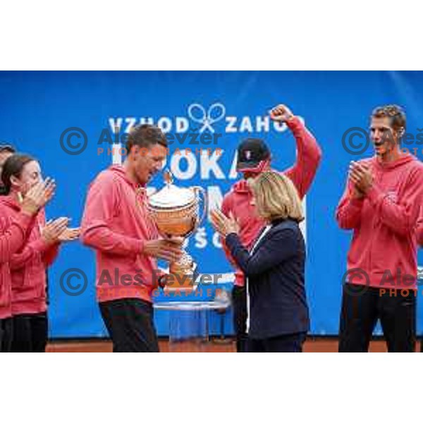 Robi Cokan, captain of Team East, winner of inaugural Mima Cup tennis match between best Slovenian players in RCU, Lukovica, Slovenia on June 8 , 2020 receives a ttrophy from Mima Jausevec