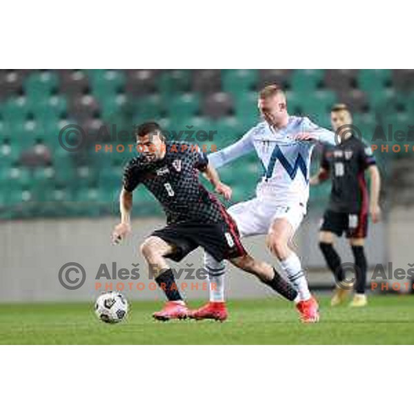 Mateo Kovacic and Blaz Kramer in action during FIFA World Cup Qualifying round match between Slovenia and Croatia in Ljubljana, Slovenia on March 24, 2021