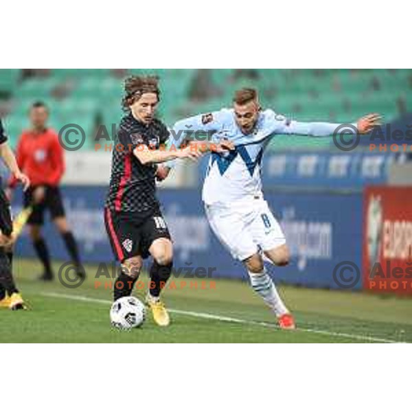 Luka Modric and Sandi Lovric in action during FIFA World Cup Qualifying round match between Slovenia and Croatia in Ljubljana, Slovenia on March 24, 2021