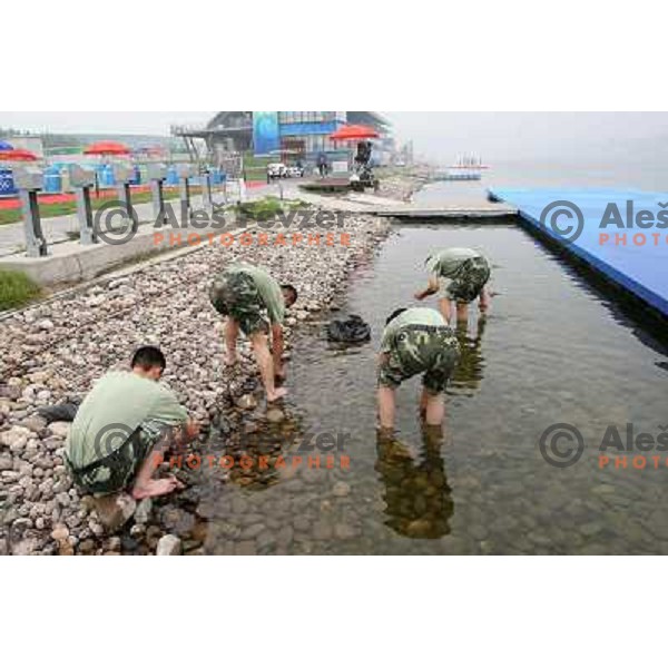 Soldiers removing seaweed before Rowing practice at Shunyi Olympic Park rowing course , Olympic games Beijing, China 8.8.2008 