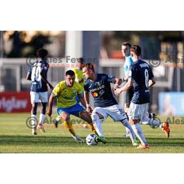Jakoslav Stankovic of Bravo and Veljko Mijailovic of Koper in action at Prva liga Telemach 2024/2025 football match between Koper and Bravo Big Bang at Bonifika Stadium in Koper, Slovenia on April 19, 2025