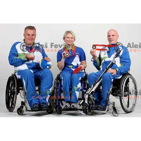 Joze Flere (left), Mateja Pintar (middle), Franc Pinter (right) of Slovenia Paraolympic team showing medals from Paraolympic Games in Beijing, China, september 2008. 