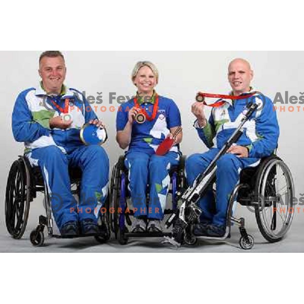 Joze Flere (left), Mateja Pintar (middle), Franc Pinter (right) of Slovenia Paraolympic team showing medals from Paraolympic Games in Beijing, China, september 2008. 