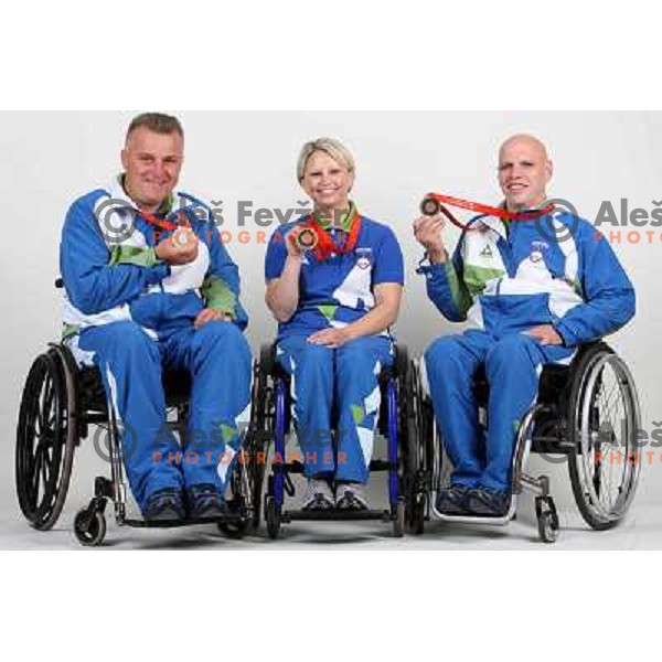 Joze Flere (left), Mateja Pintar (middle), Franc Pinter (right) of Slovenia Paraolympic team showing medals from Paraolympic Games in Beijing, China, september 2008. 