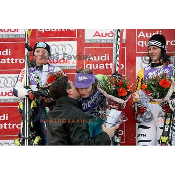 Second placed Denise Karbon (ITA,left) ,winner Tina Maze (SLO) receives kiss from Borut Pahor and third placed Kathrin Hoelzl (GER) at victory podium oft 45.Golden fox- Zlata Lisica Audi FIS World Alpine skiing giant slalom in Maribor, Slovenia 10.1.2009 