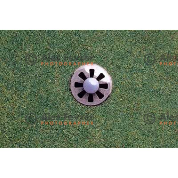 Golf shoes and putter on the green during a round of golf in Slovenia, Europe