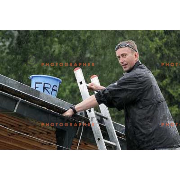 Karli Zust fixing the roof of Zaka Boat House during Rowing World Cup, Bled, Slovenia 29.5.2010 