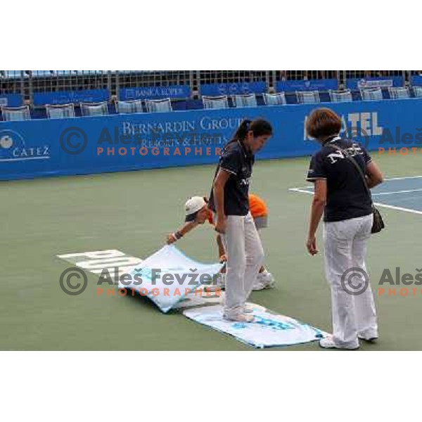 Ball boy and referees wipe the court after rain shower during the quarter-finals of WTA Banka Koper Slovenia Open tennis tournament, played in SRC Marina, Portoroz, Slovenia on July 23, 2010 
