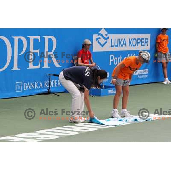 Ball boy and referee wipe the court after rain shower during the quarter-finals of WTA Banka Koper Slovenia Open tennis tournament, played in SRC Marina, Portoroz, Slovenia on July 23, 2010 