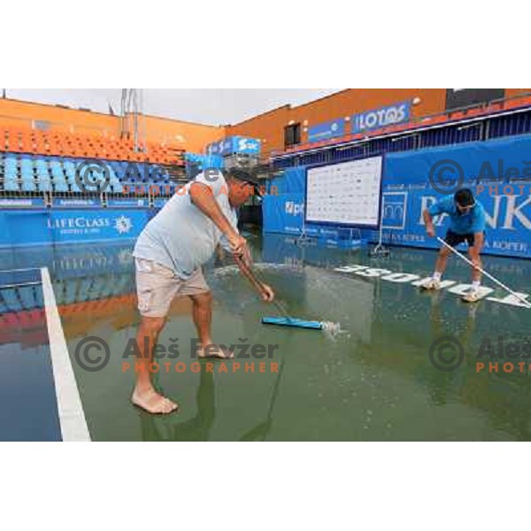 Tournament staff wipe centre court after heavy shower before start of semi-final of WTA Banka Koper Slovenia Open tennis tournament, played in SRC Marina, Portoroz, Slovenia on July 24, 2010 