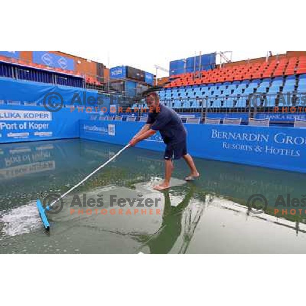 Tournament staff wipe centre court after heavy shower before start of semi-final of WTA Banka Koper Slovenia Open tennis tournament, played in SRC Marina, Portoroz, Slovenia on July 24, 2010 