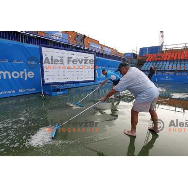 Tournament staff wipe centre court after heavy shower before start of semi-final of WTA Banka Koper Slovenia Open tennis tournament, played in SRC Marina, Portoroz, Slovenia on July 24, 2010 