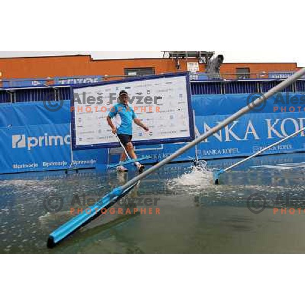 Tournament staff wipe centre court after heavy shower before start of semi-final of WTA Banka Koper Slovenia Open tennis tournament, played in SRC Marina, Portoroz, Slovenia on July 24, 2010 