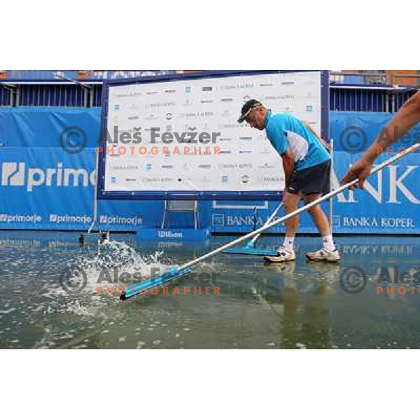 Tournament staff wipe centre court after heavy shower before start of semi-final of WTA Banka Koper Slovenia Open tennis tournament, played in SRC Marina, Portoroz, Slovenia on July 24, 2010 
