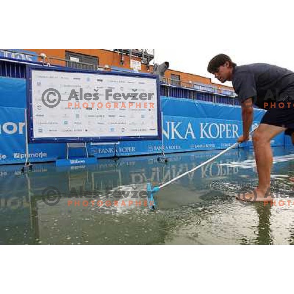 Tournament staff wipe centre court after heavy shower before start of semi-final of WTA Banka Koper Slovenia Open tennis tournament, played in SRC Marina, Portoroz, Slovenia on July 24, 2010 