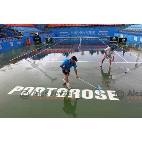 Tournament staff wipe centre court after heavy shower before start of semi-final of WTA Banka Koper Slovenia Open tennis tournament, played in SRC Marina, Portoroz, Slovenia on July 24, 2010 
