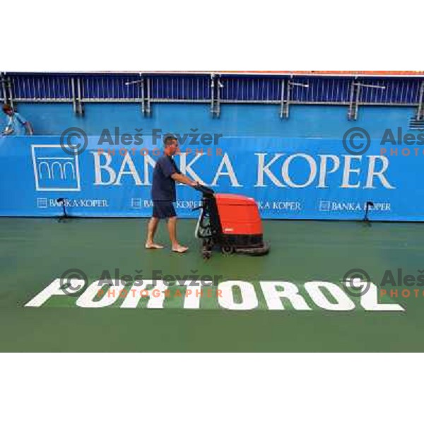 Tournament staff wipe centre court after heavy shower before start of semi-final of WTA Banka Koper Slovenia Open tennis tournament, played in SRC Marina, Portoroz, Slovenia on July 24, 2010 