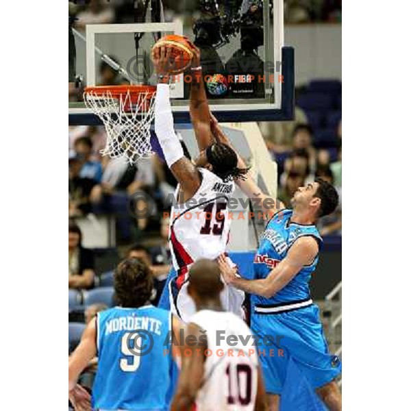 Matteo Soragna tries to stop Carmelo Anthony from dunking