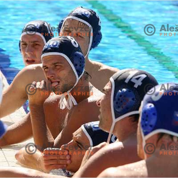 Tomaz Mihelcic with his teammates listens to coach during time-out