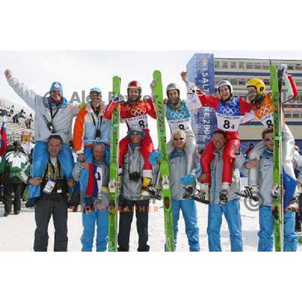 Coach Matjaz Zupan, Robert Kranjec, Primoz Peterka, Damjan Fras, Peter Zonta of Slovenia with bronze olympic medal at team ski- jumping competition in Winter Olympic games in Salt Lake City, USA on February 2002 