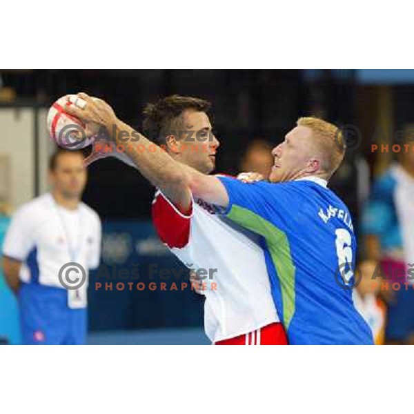 Ivano Balic of Croatia and Andrej Kastelic of Slovenia in action during Handball tournament at Summer Olympic Games Athens 2004, Greece. Slovenia played with Croatia on August 15, 2004 