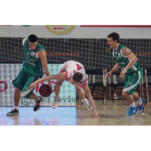 Uros Zadnik of Geoplin Slovan and Vladimir Panic, Danijel Vujasinovic of Zlatorog in action during basketball match in quarter-final of Spar Cup, played in Poden Sports Hall, Skofja Loka, Slovenia on Feburary 11, 2011 