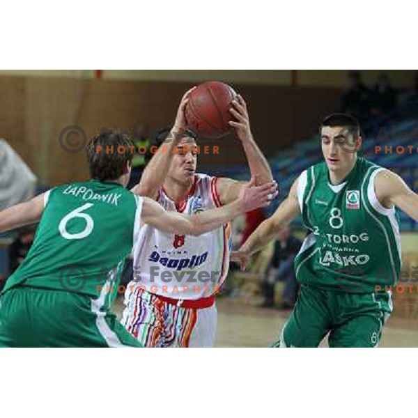 Miha Fon of Geoplin Slovan and Luka Lapornik, Vladimir Panic in action during basketball match in quarter-final of Spar Cup, played in Poden Sports Hall, Skofja Loka, Slovenia on Feburary 11, 2011 