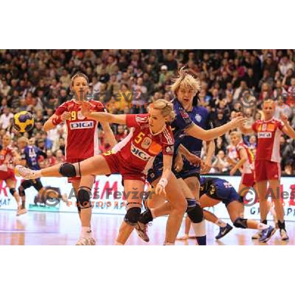 Marina Vergelyuk of Krim Mercator (SLO) and Curea of Oltchim Valcea (ROM) in action during handball match in Women\'s Championsleague played in Valcea, Romania on February 20, 2011 