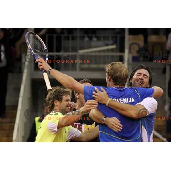 Coach Ziga Janskovec, Blaz Kavcic, Luka Gregorc, Grega Zemlja, Captain Blaz Trupej and players and staff of Slovenia celebrate victory 3:2 in Davis Cup match Slovenia- Finland, played in Hala Tivoli, Ljubljana, Slovenia on March 6, 2011 