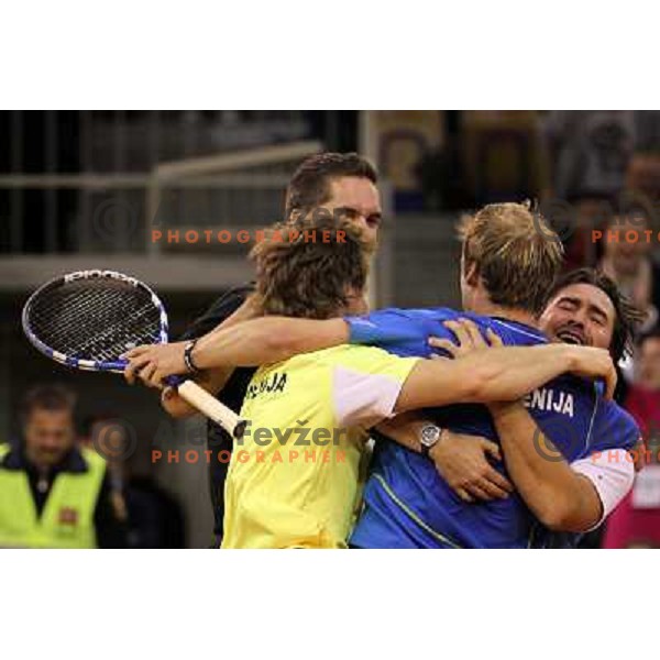 Coach Ziga Janskovec, Blaz Kavcic, Luka Gregorc, Grega Zemlja, Captain Blaz Trupej and players and staff of Slovenia celebrate victory 3:2 in Davis Cup match Slovenia- Finland, played in Hala Tivoli, Ljubljana, Slovenia on March 6, 2011 