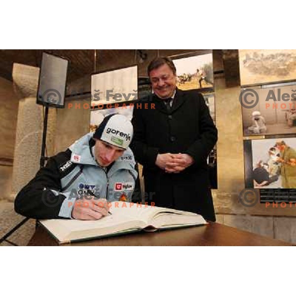 Robi Kranjec signing book of honour for Medal winners from Slovenia at 2010 Oslo Nordic World Championships at official reception in front of Ljubljana Town Hall, Slovenia on March 8, 2011 