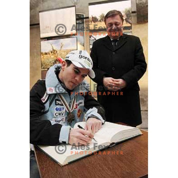 Jernej Damjan signing book of honour for Medal winners from Slovenia at 2010 Oslo Nordic World Championships at official reception in front of Ljubljana Town Hall, Slovenia on March 8, 2011 