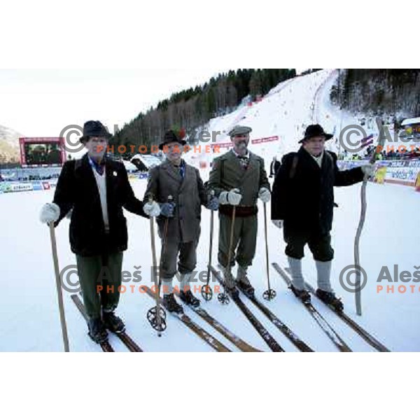 Skiers showing traditional skies and equipment during world cup race in Kranjska gora