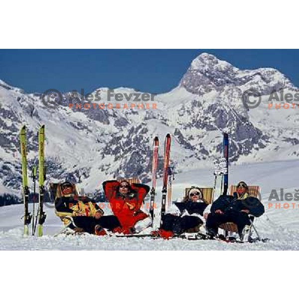 Skiers enjoying sun at Vogel ski resort with Mt.Triglav in background