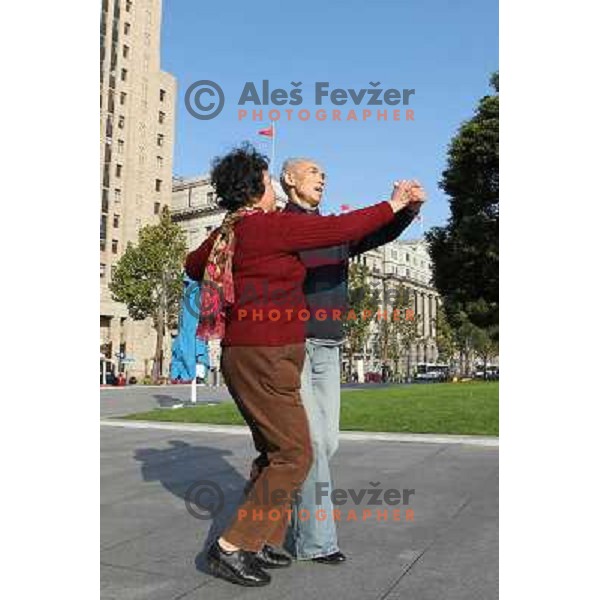 Couple dancing in front of Mao Tse-tung statue at the Bund in Shanghai. Located in the Yangtze River Delta in eastern China, Shanghai has more than 25 million people. It is a popular tourist destination renowned for its historical landmarks and new urban 