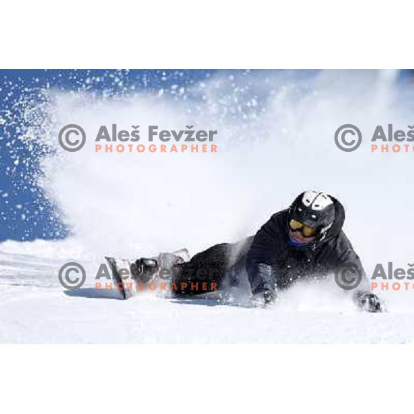 Snowboarder at Krvavec Ski resort ( 1450 meters - 1971 meters) with 30 km of groomed tracks in early spring, Cerklje na Gorenjskem on March 22 ,2013 