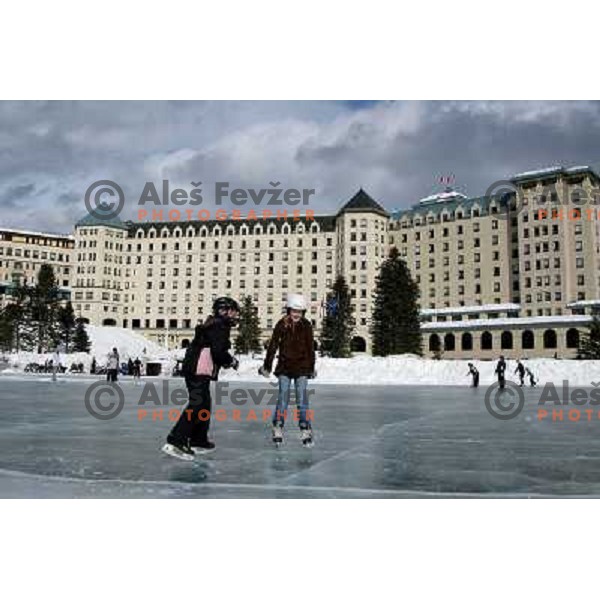 Ice skaters in front of Fairmont hotel skate on frozen Lake Louise, RCR ski resort in Canadian Rockies,Alberta, Canada on 2nd of March 2008. Photo by Ales Fevzer 